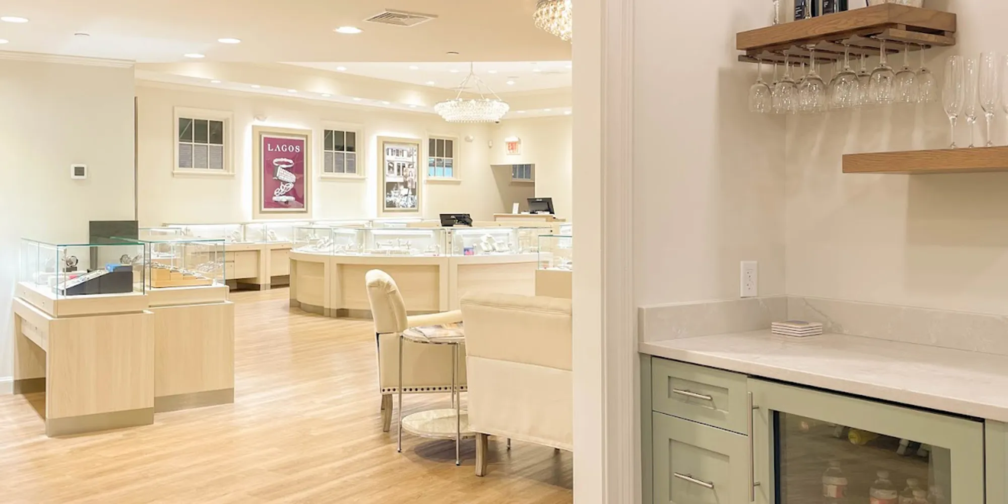 Interior of Hingham Jewelers with display cases, seating, and a small bar area.