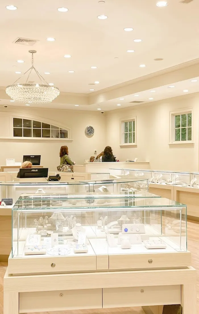 Bright jewelry store interior with display cases and customers. Get Directions to Hingham Jewelers.