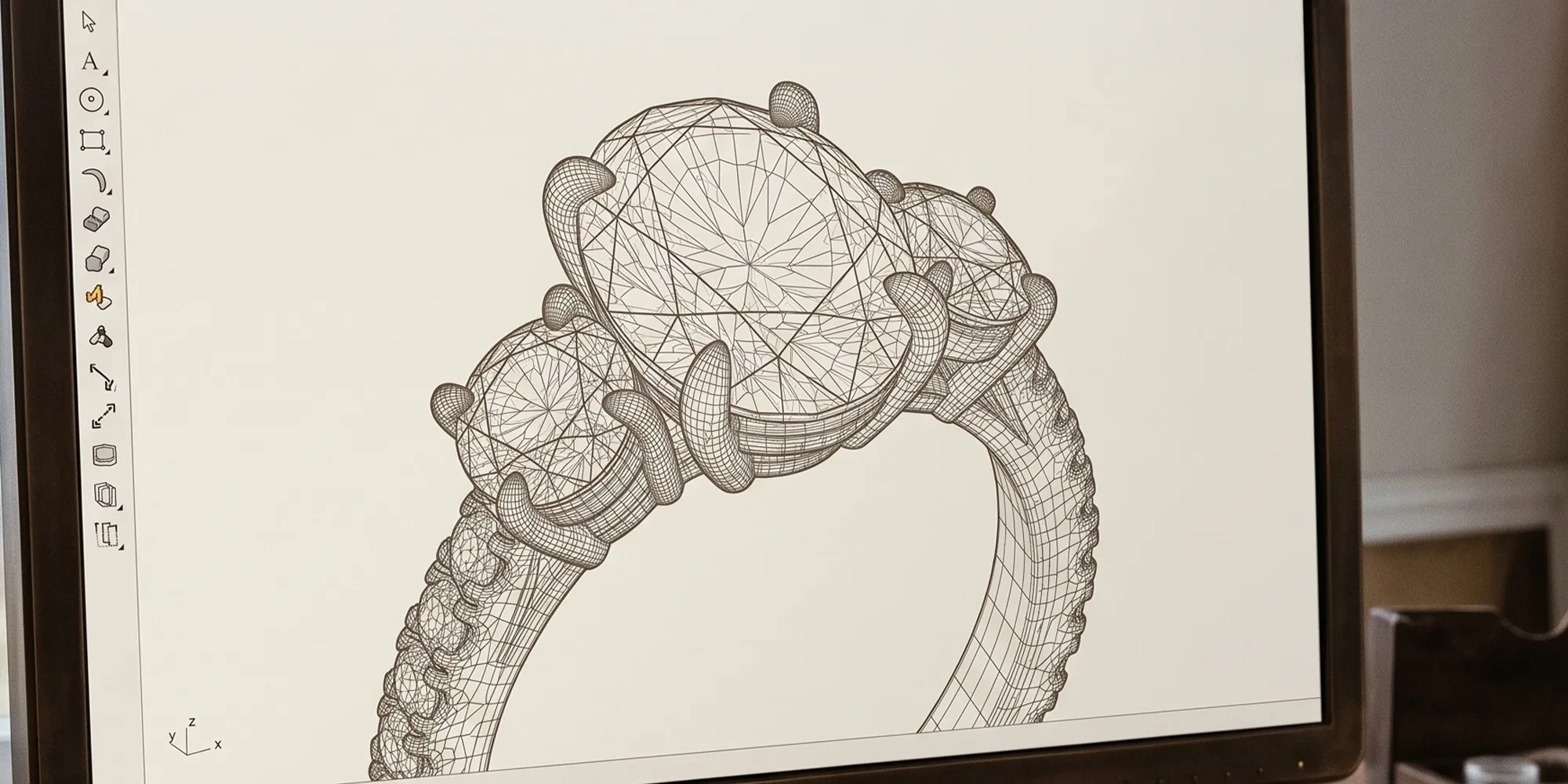 CAD modeling of a three-stone ring design on a computer screen at Hingham Jewelers, MA.
