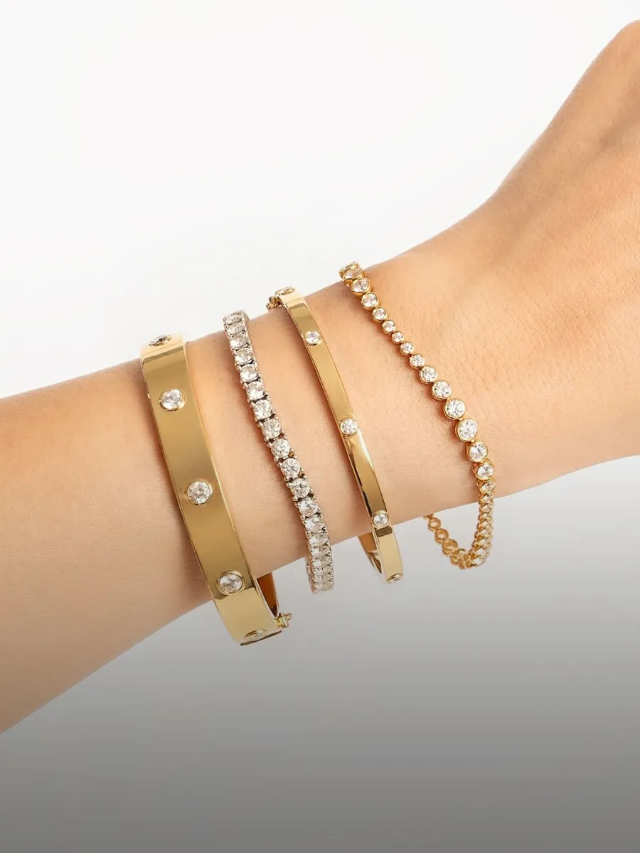 Diamond and gold bracelets on wrist. Shop diamond bracelets at Hingham Jewelers.