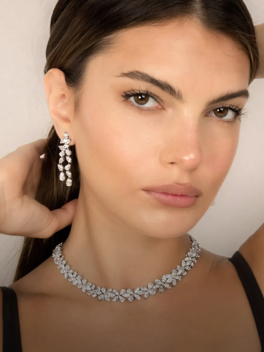 Diamond earrings and necklace worn by a woman. Shop at Hingham Jewelers South Shore MA.