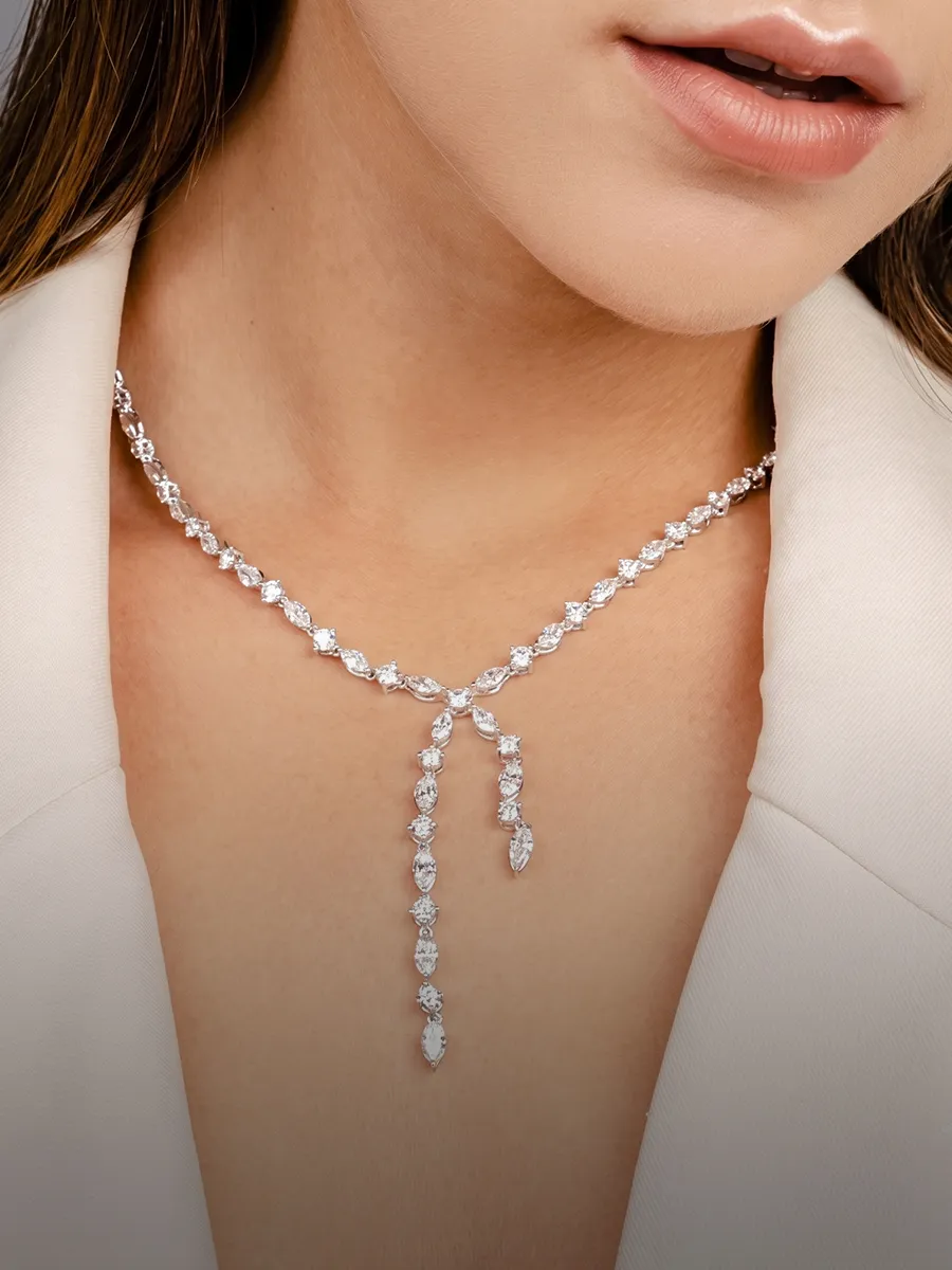 Woman wearing a sparkling diamond necklace. Shop necklaces at Hingham Jewelers.