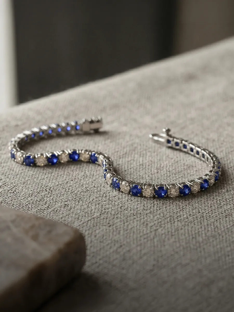 Elegant bracelet with blue and clear stones on a textured surface.