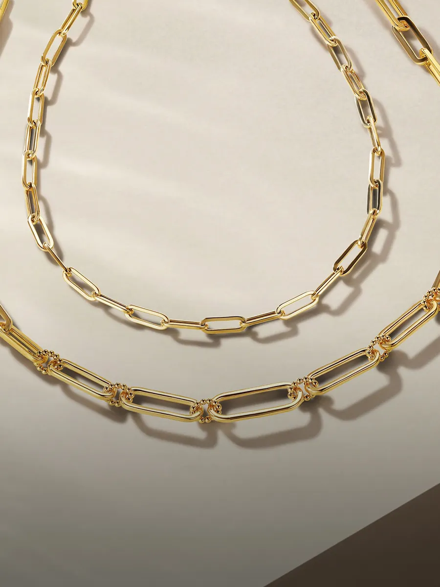Gold and silver chain necklaces on a neutral background. Shop chains at Hingham Jewelers.