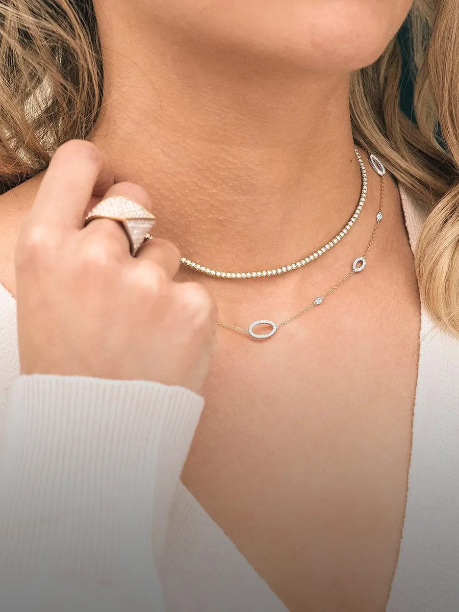 Woman wearing layered necklaces and a large ring. Shop necklaces at Hingham Jewelers South Shore MA.