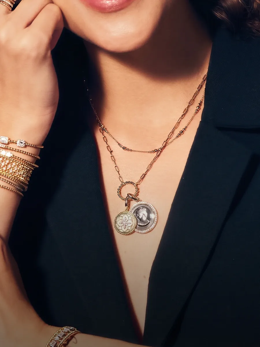 Woman wearing layered necklaces with pendants and bracelets. Shop pendants at Hingham Jewelers South Shore MA.