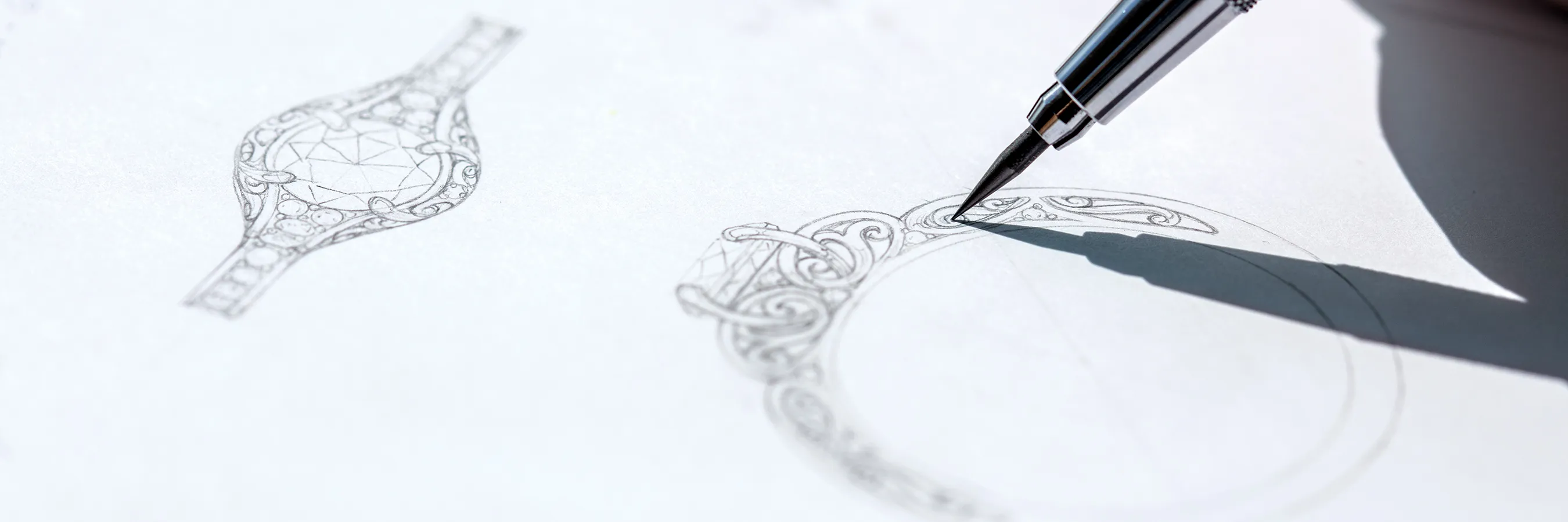 A detailed sketch of an ornate ring being drawn with a mechanical pencil.
