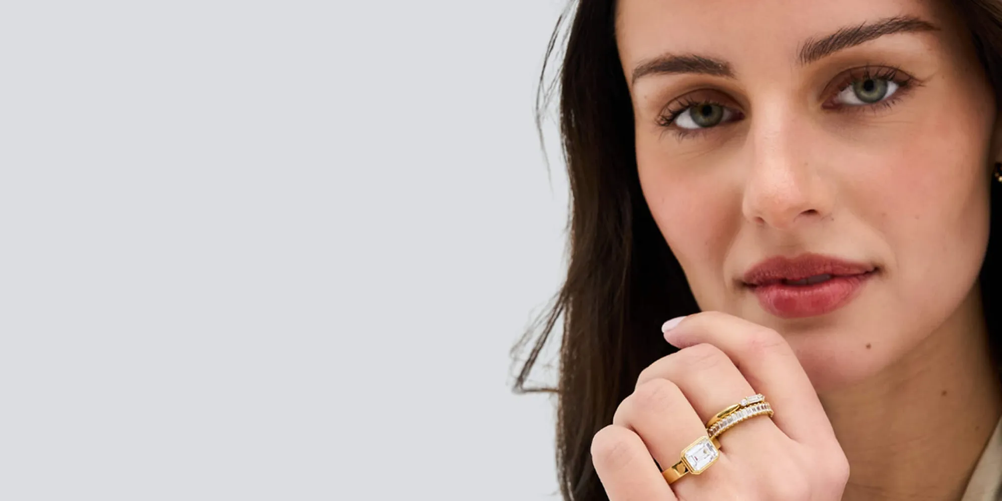 Close-up of a person wearing gold and diamond rings, with a focus on the jewelry.