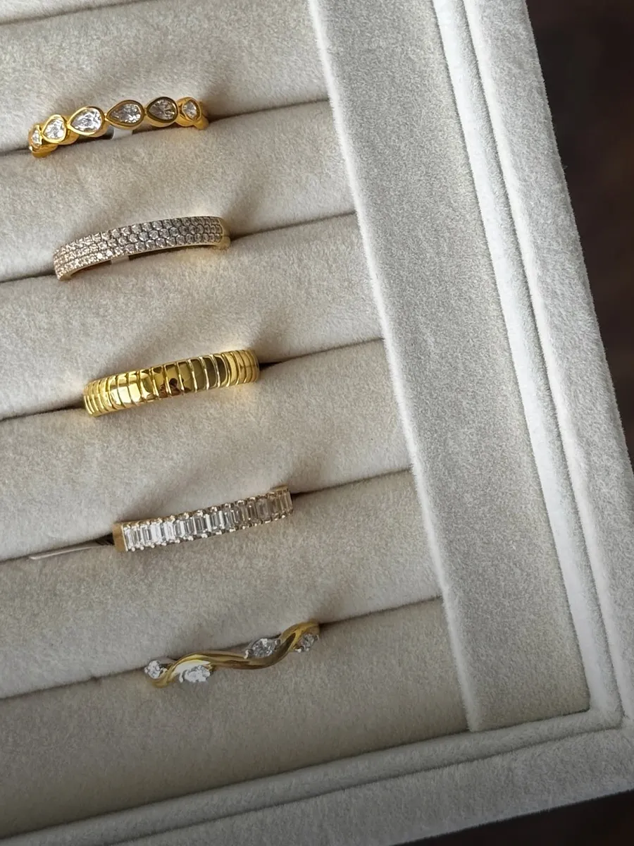 Five elegant women's wedding bands displayed in a velvet-lined jewelry box.