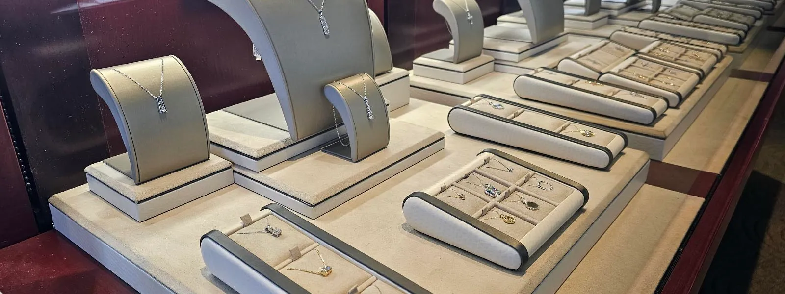 Jewelry display featuring necklaces, earrings, and rings at Holliday Jewelry in Klamath Falls. Click for job openings and benefi