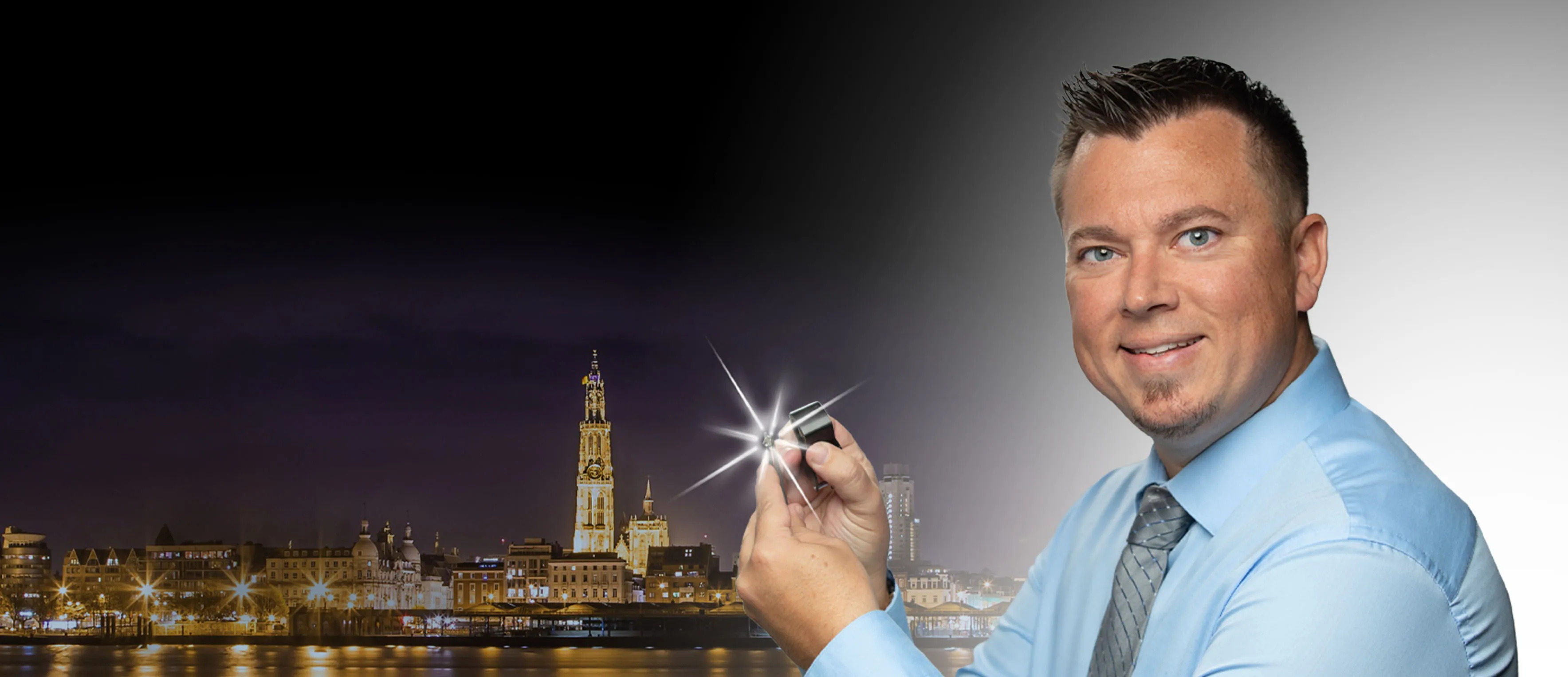 Win a free diamond in the Antwerp Diamond Giveaway! Image of the Antwerp skyline at night and man holding a diamond.