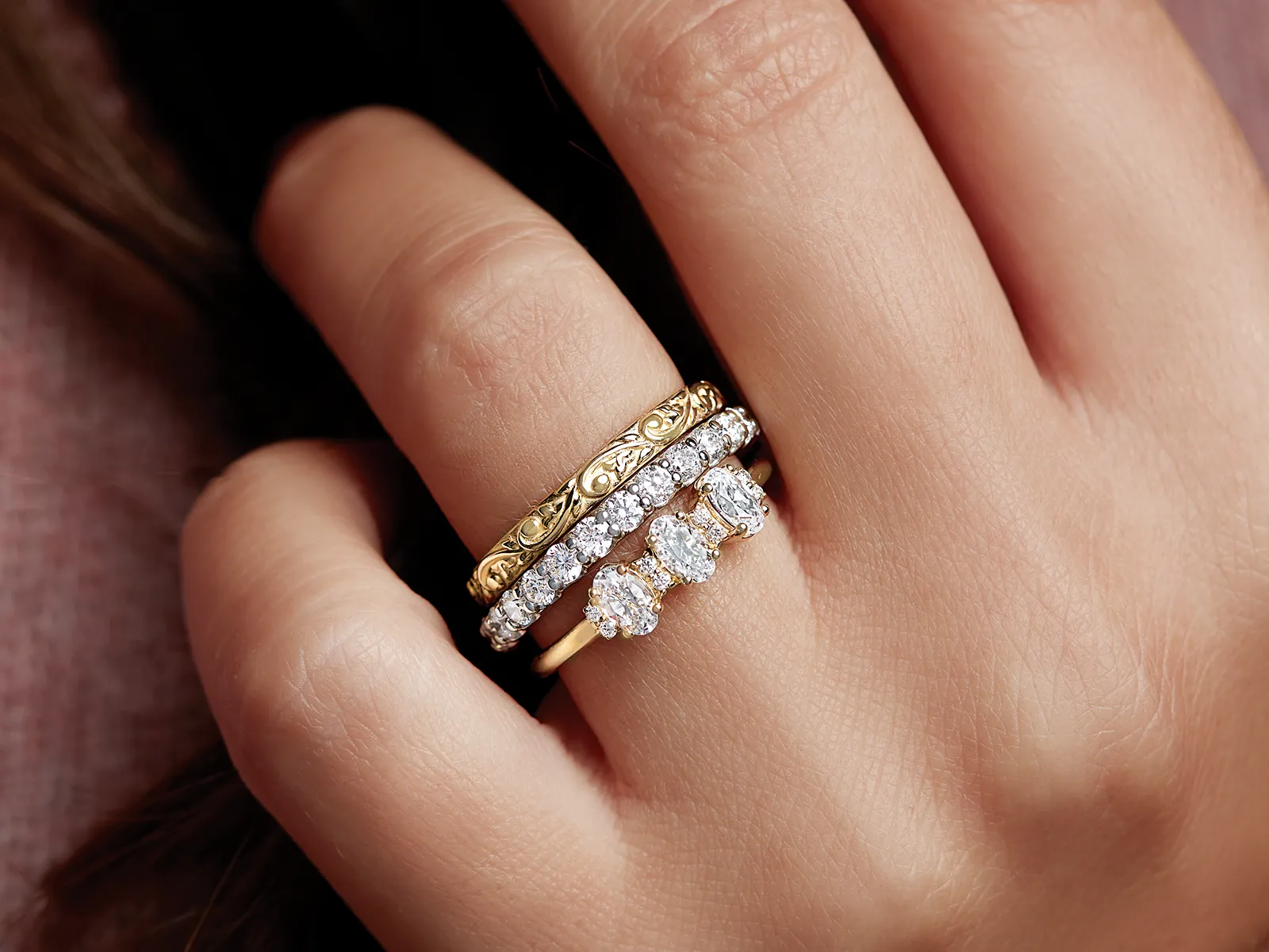 Wood and silver ring displayed on a stone surface. 