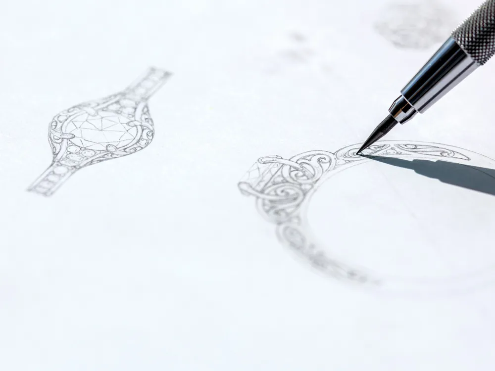 Jewelry design sketch with a pencil drawing intricate ring details, showcasing craftsmanship.