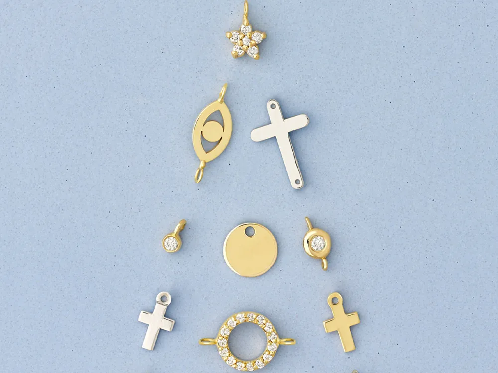 Gold and silver charms arranged in a triangle shape on a blue background.