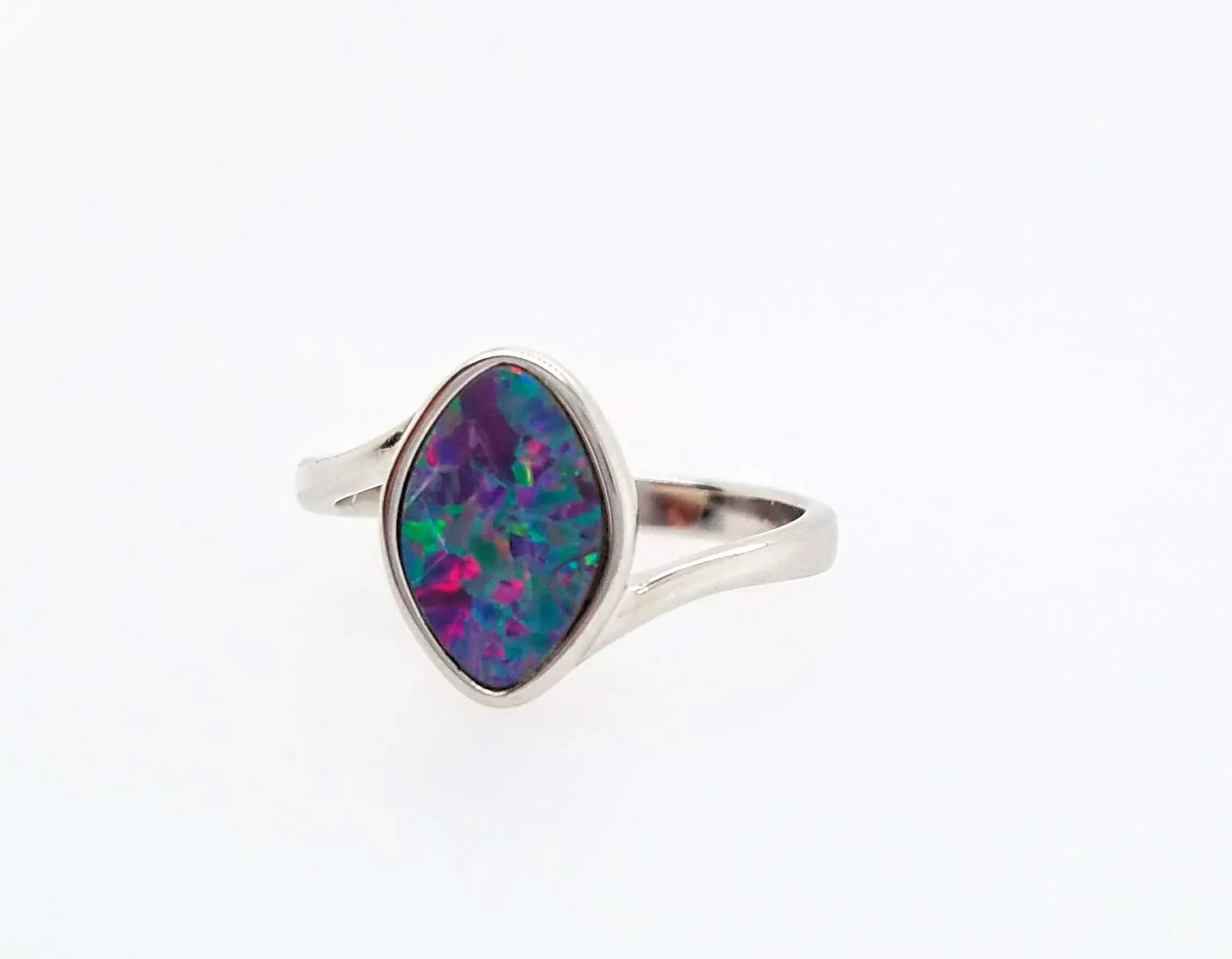 Silver ring with a vibrant, multicolored opal stone set in the center.