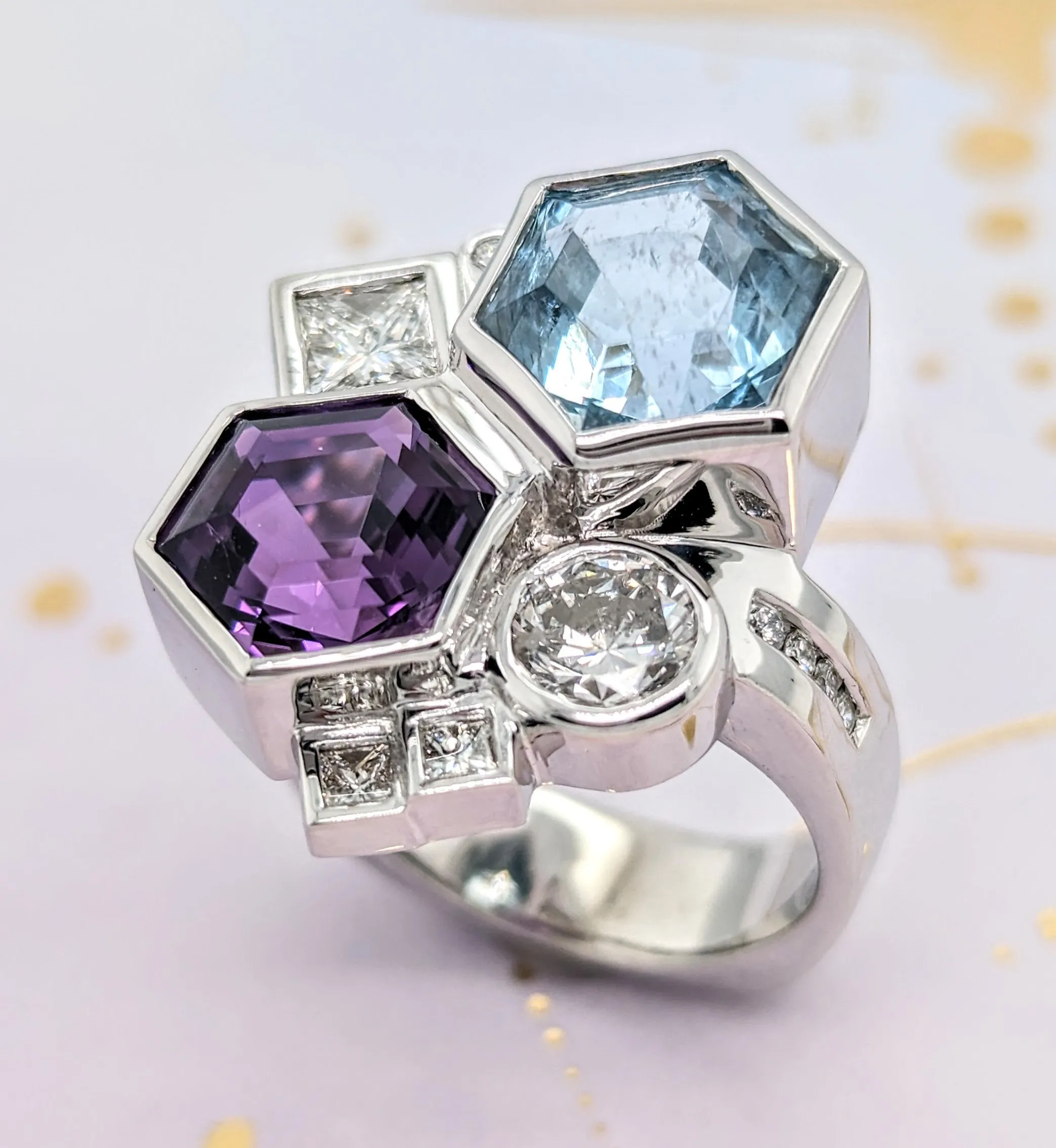 Custom Colorful hexagon-shaped ring featuring amethyst, aquamarine, and diamond accents. Click to start your custom design at Ho