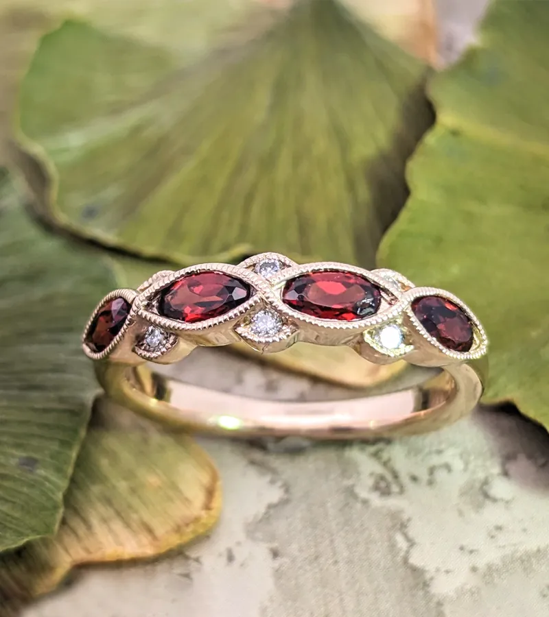 Custom designed Elegant rose gold ring featuring marquise-cut red gemstones and diamonds, perfect for anniversaries. 