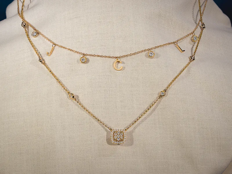 Diamond necklace with a Y-shaped design on a dark velvet background.
