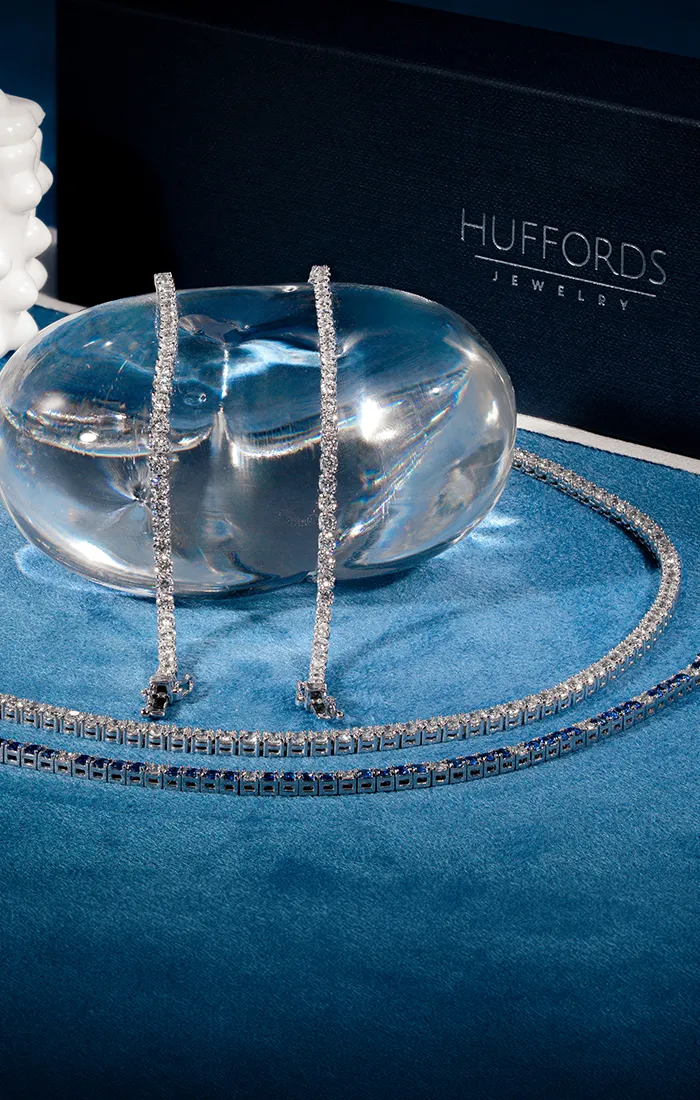 Gold and diamond star-shaped jewelry set on blue display stands.