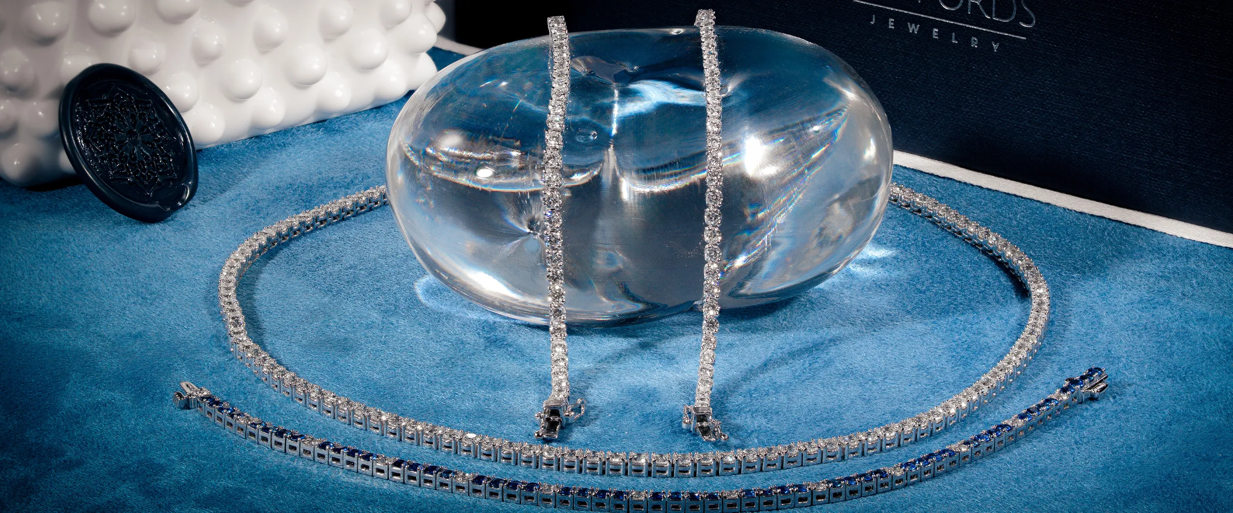 Gold and diamond star-shaped jewelry set on blue display stands.