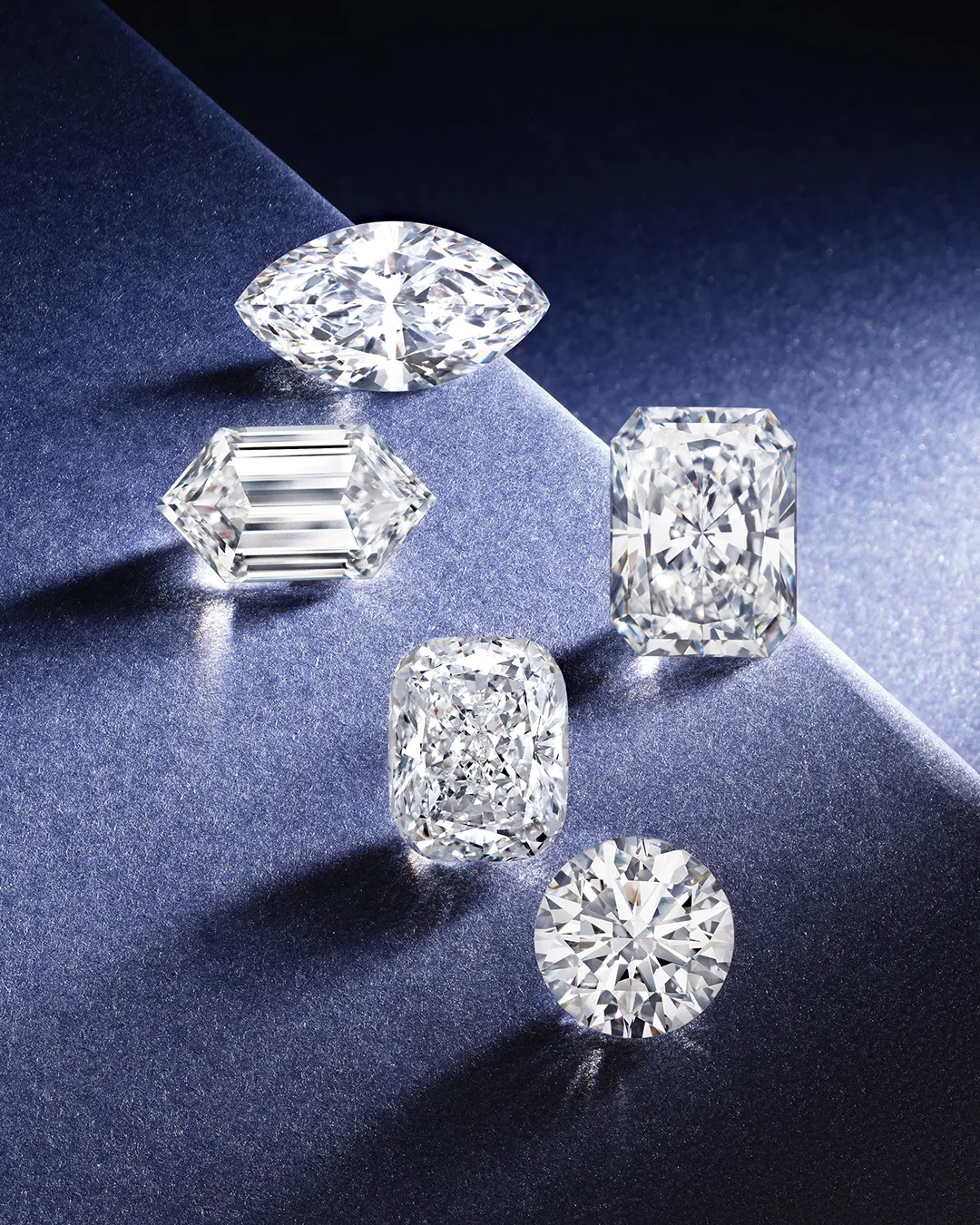 Small diamonds on a blue surface. Learn more about the Four Cs of Diamonds.