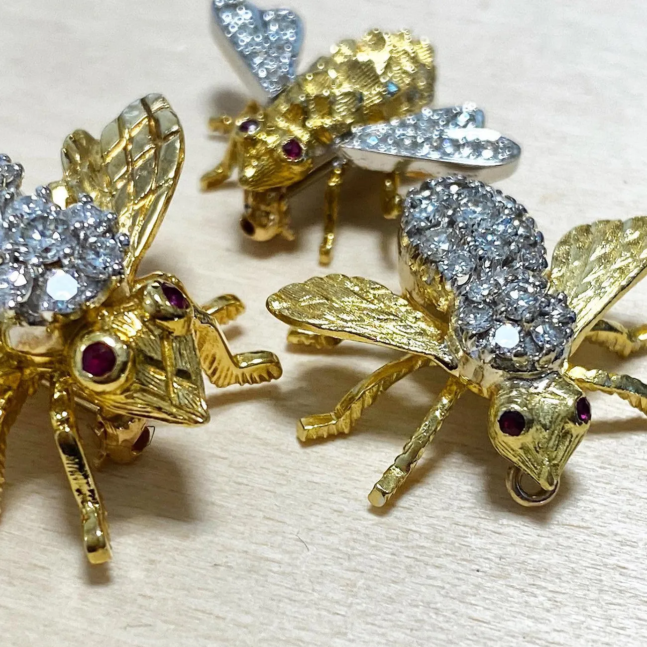 Elegant diamond brooch with leaf design on dark fabric.