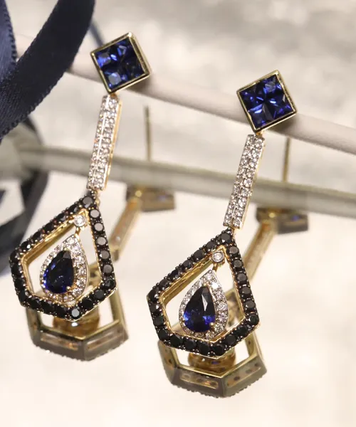 Elegant gold earrings featuring blue stones and sparkling diamonds, perfect for any occasion.