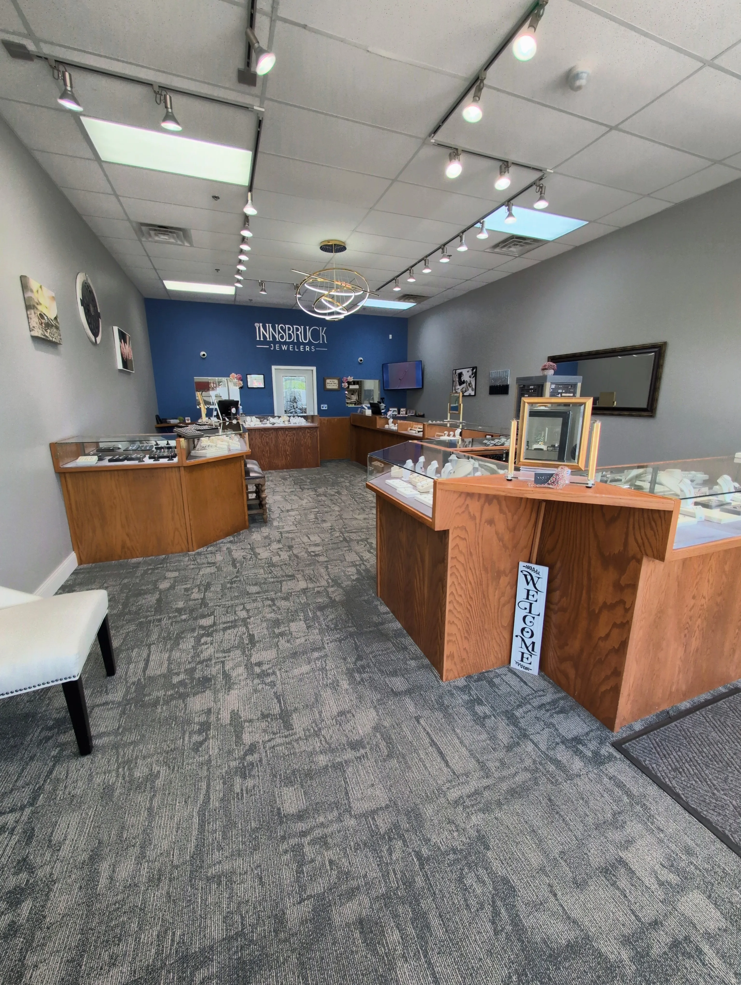 A brick building with blue doors and signage for Innsbruck Jewelers, Silver Lake Chiropractic, and Silver Shear.