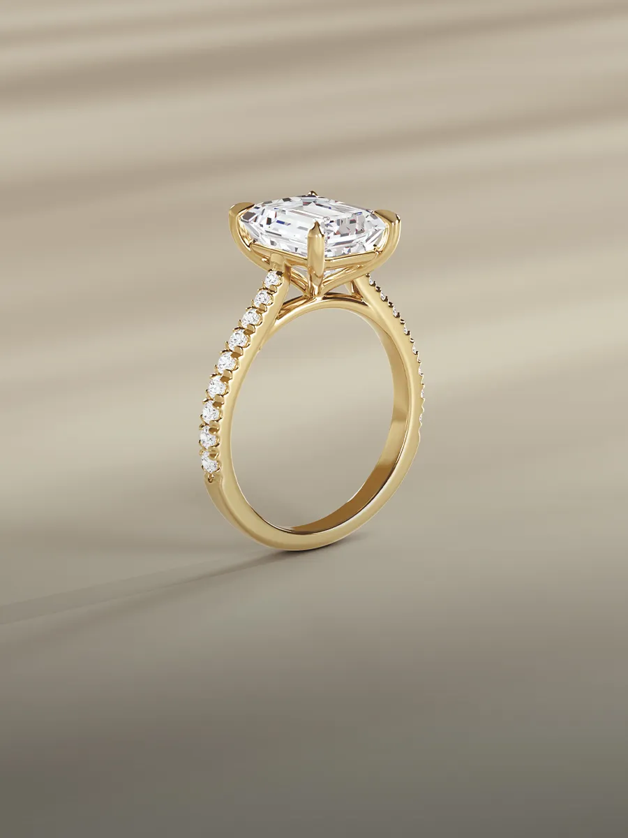 A gold engagement ring with a large oval diamond and smaller diamonds on the band.