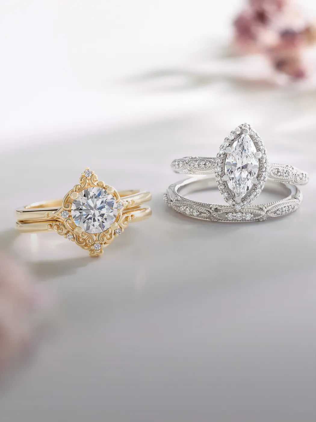 Two elegant halo rings, one in gold with a round diamond and one in silver with a marquise diamond, on a soft background.