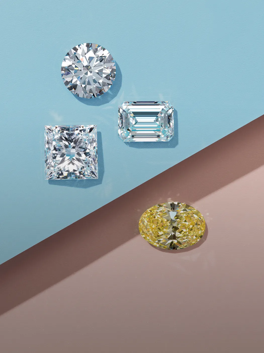 Four diamonds in various cuts on a blue and brown background.