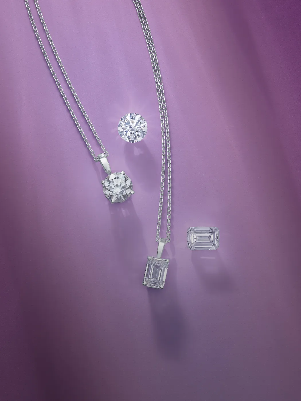 Diamond necklaces and loose diamonds on a purple background.