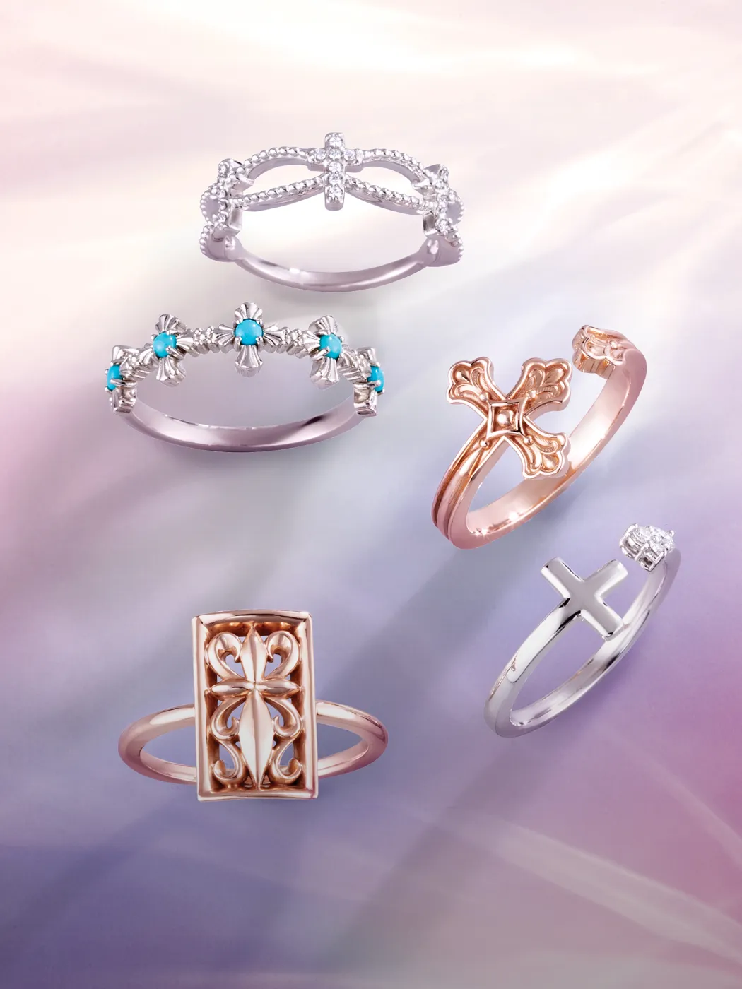 Five intricately designed rings with religious motifs on a soft gradient background.
