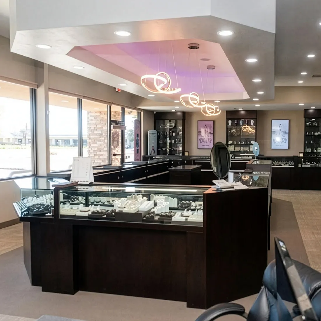 Modern jewelry store interior with display cases, elegant lighting, and a welcoming atmosphere at J.A. Jewelers in Farmington.