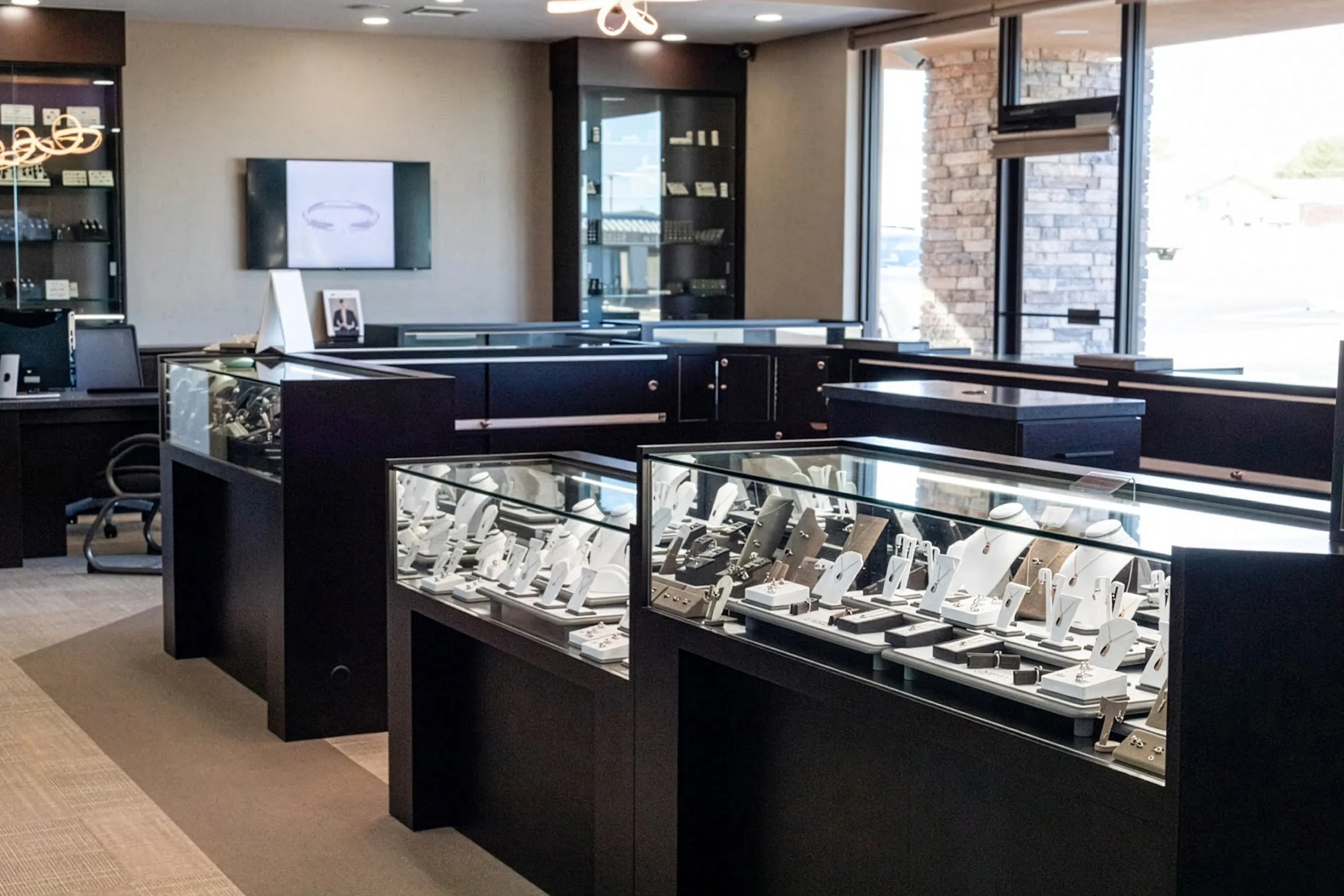 Jewelry display cases in a modern store interior at J.A. Jewelers & Company, Inc. in Farmington. Click for directions.