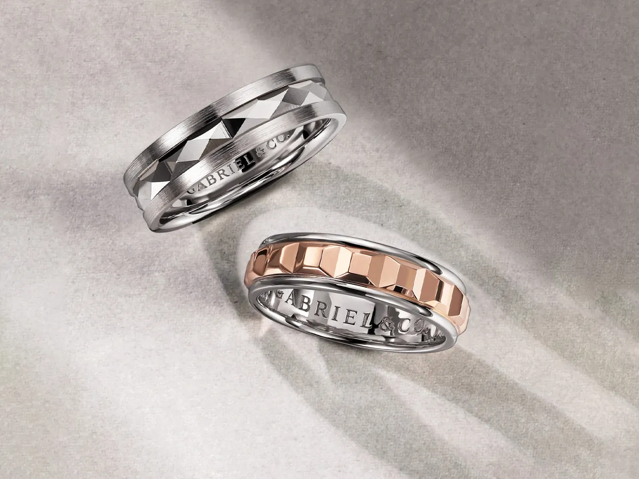 Two stylish rings, one silver and one rose gold, displayed on a soft background. Visit J.A. Jewelers & Co. for more.