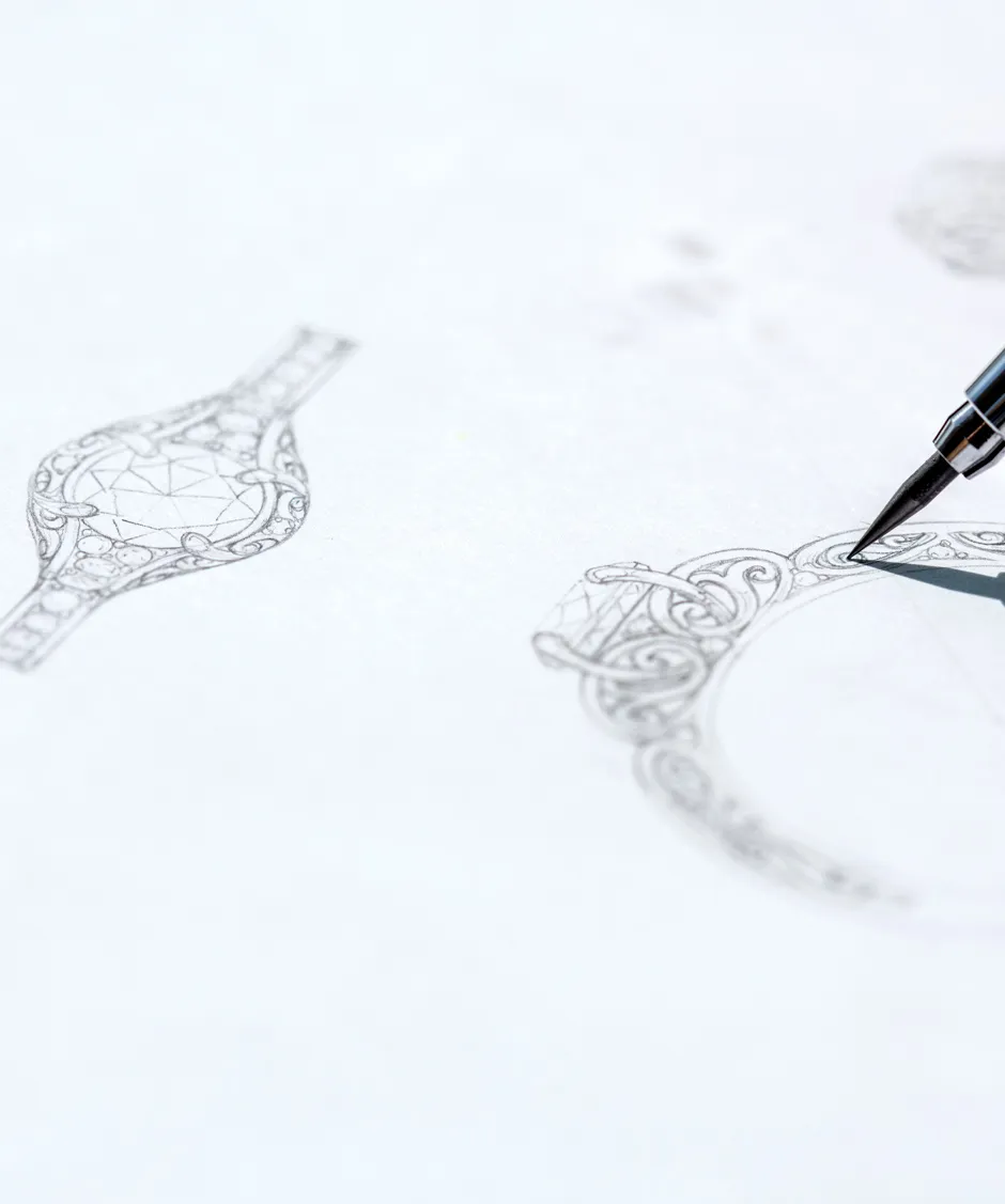 A detailed sketch of a jewelry design with a pen, showcasing intricate patterns and shapes.