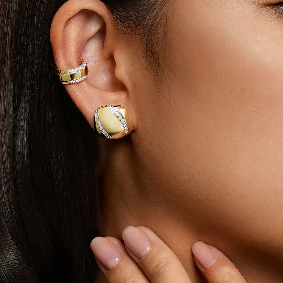 Gold and diamond earrings worn by a model, showcasing elegant jewelry from J.A. Jewelers & Company, Inc. in Farmington.