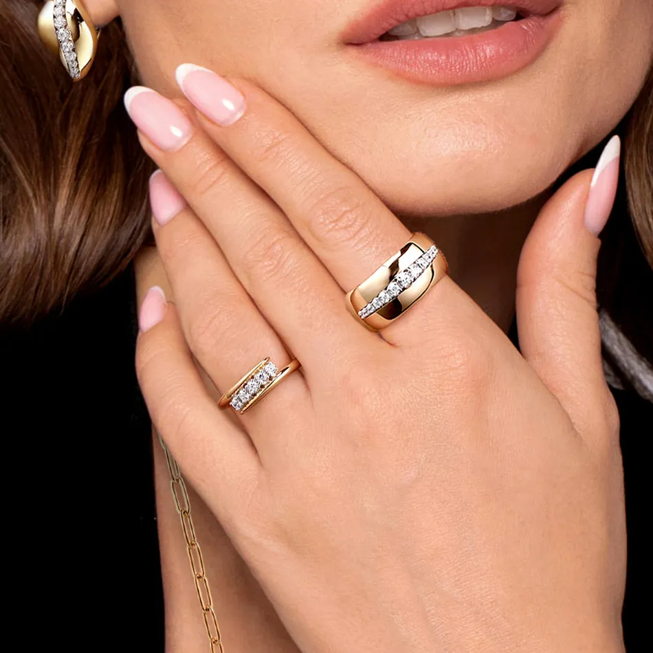 Elegant rings displayed on a woman's hand, showcasing gold and diamond designs. Visit J.A. Jewelers & Co. for more.