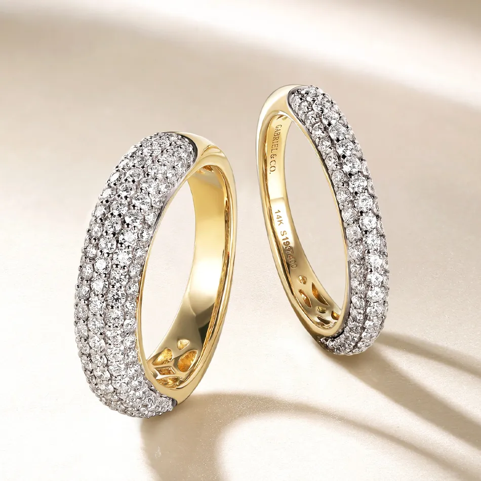 Elegant 14K gold wedding bands adorned with sparkling diamonds, showcased by J.A. Jewelers in Farmington.