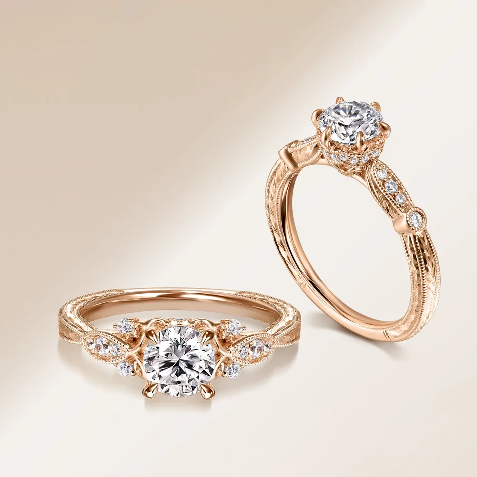 Rose gold engagement rings featuring a round diamond and intricate detailing. Visit J.A. Jewelers & Co. for more.
