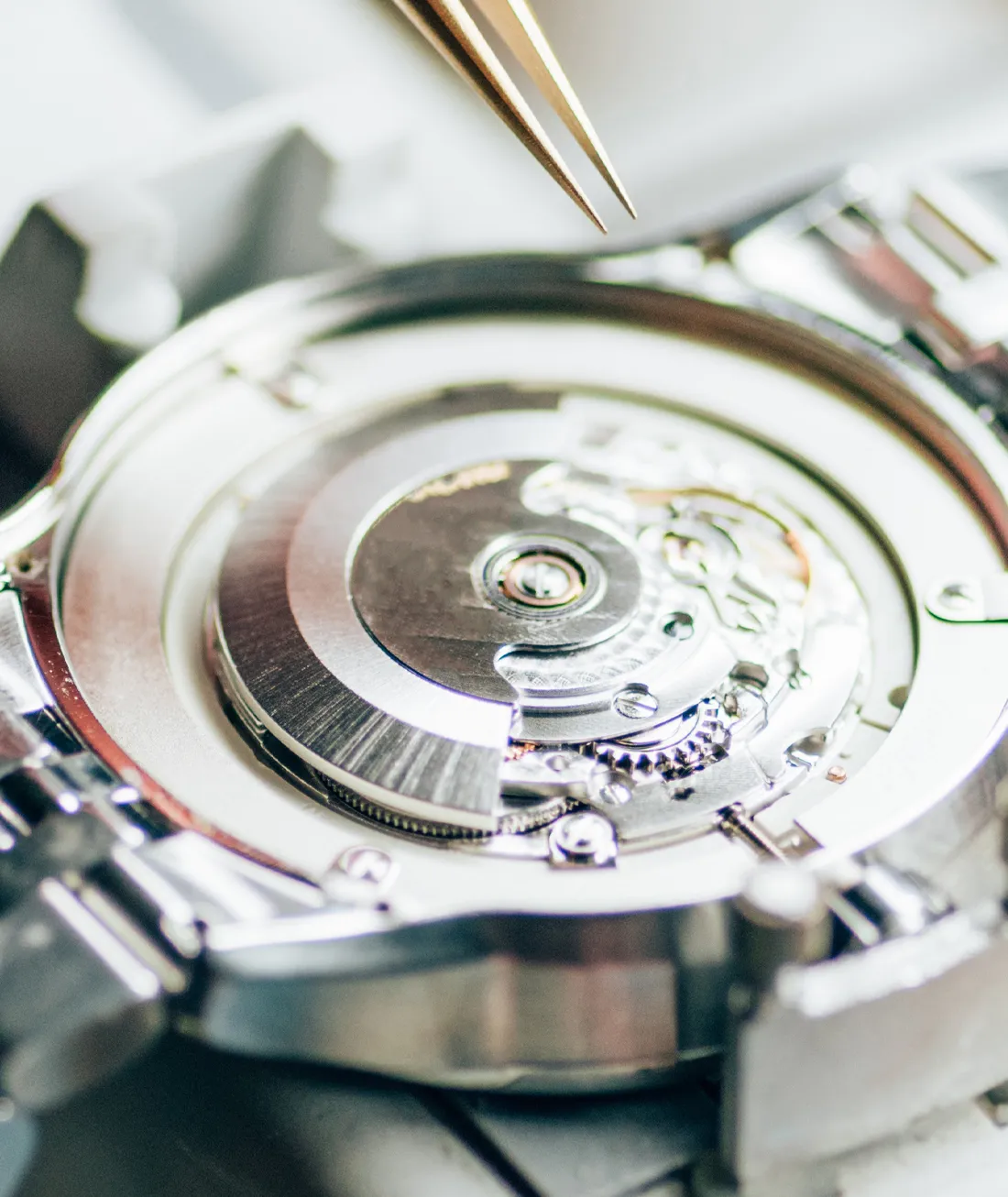 Close-up of a watch movement being repaired with tweezers at J.A. Jewelers & Company, Inc. in Farmington.