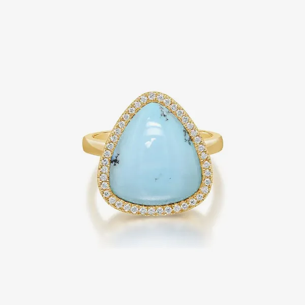 Gold ring with a large triangular blue stone and diamond halo.