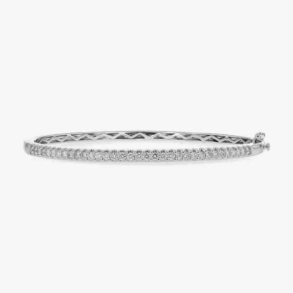 A delicate silver bangle bracelet with a row of small diamonds.