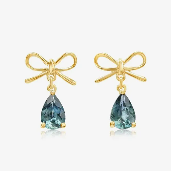 Gold bow earrings with teardrop-shaped blue gemstones.