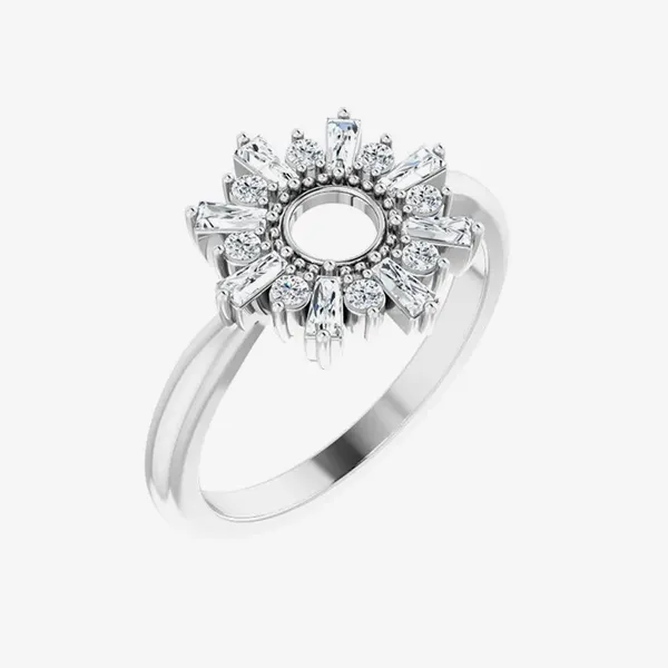 A silver ring with a sunburst design featuring baguette and round diamonds.