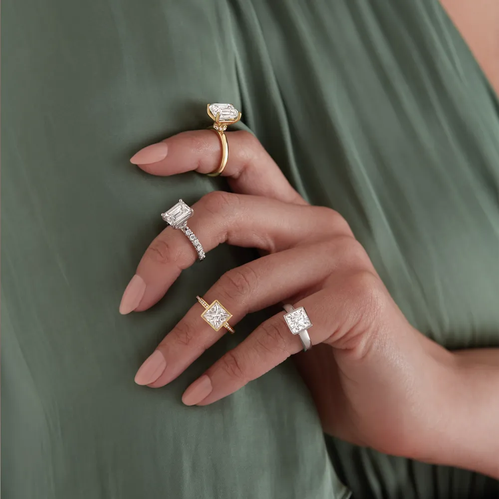 Five elegant rings displayed on a hand, showcasing various styles and settings. Shop at J. Anthony Jewelers in Neenah.
