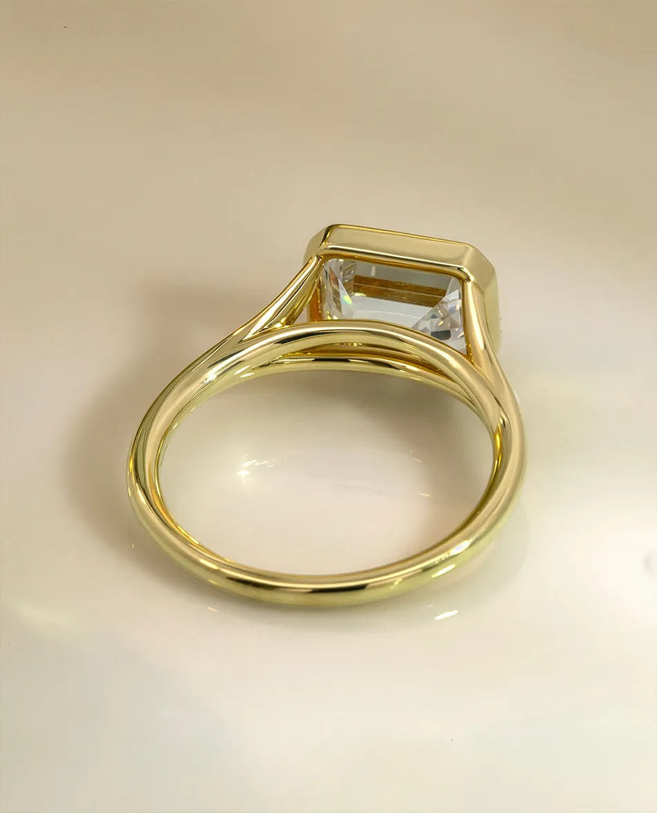 Gold ring with a large rectangular gemstone setting. Click to shop ring settings.