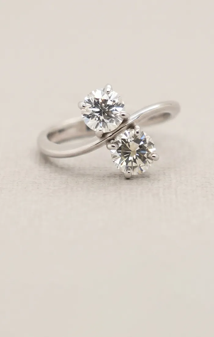 Two-stone diamond ring on a light background. Book an Appointment at Jayson Jewelers.