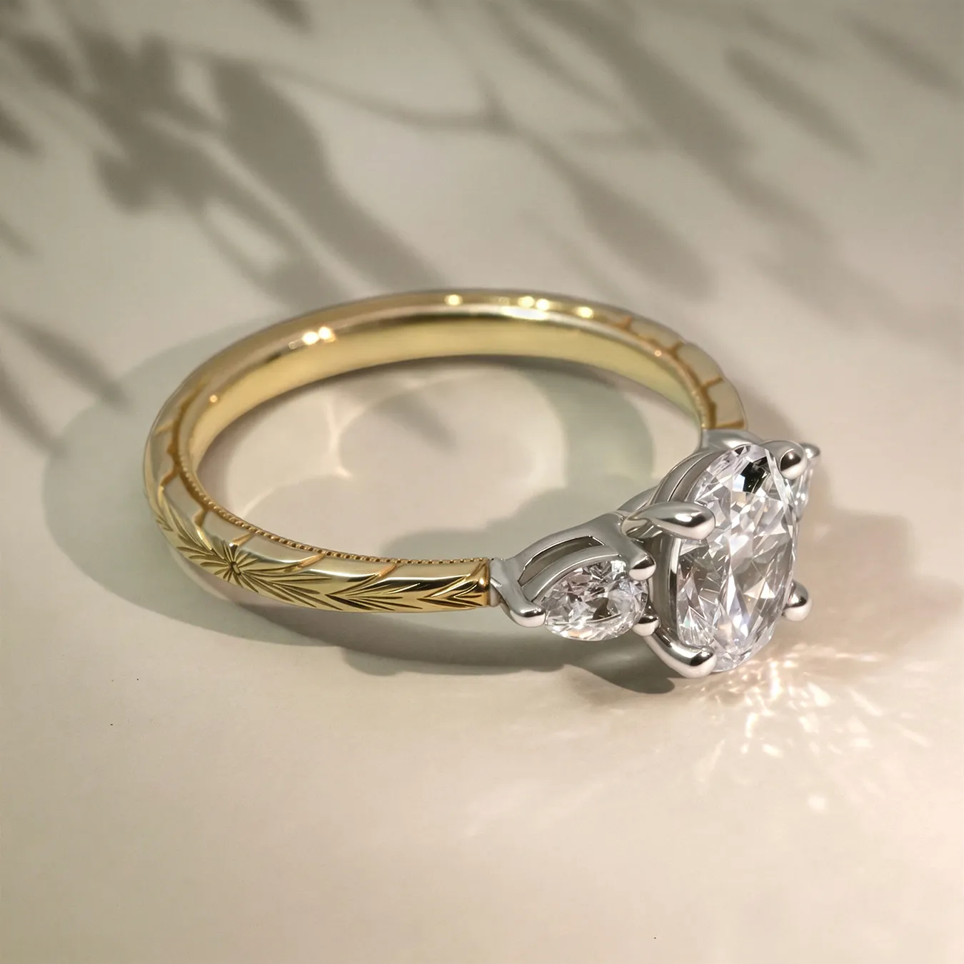 Elegant gold ring with intricate band design and large oval diamond centerpiece.